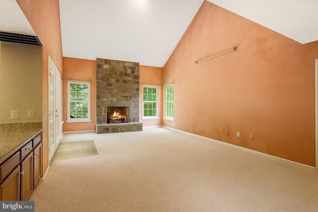 16715 Tintagel Ct, Dumfries, VA 22025 - unfurnished living room with light carpet, high vaulted ceiling, plenty of natural light, and a stone fireplace