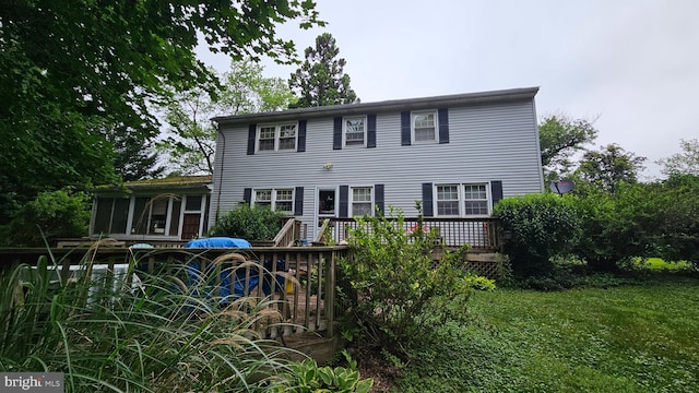 59 Singer Rd, New Freedom, PA 17349 - back of house featuring a sunroom, a deck, and a lawn