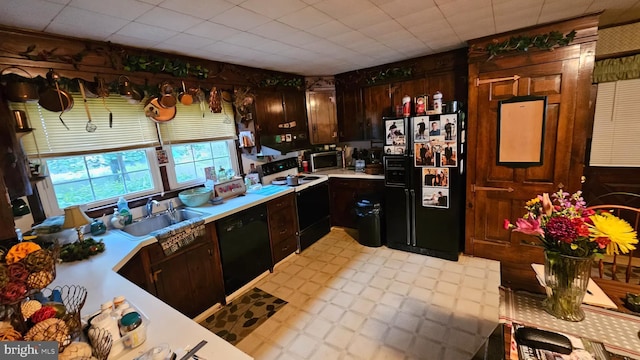 59 Singer Rd, New Freedom, PA 17349 - kitchen with black appliances, light countertops, light floors, and dark brown cabinets