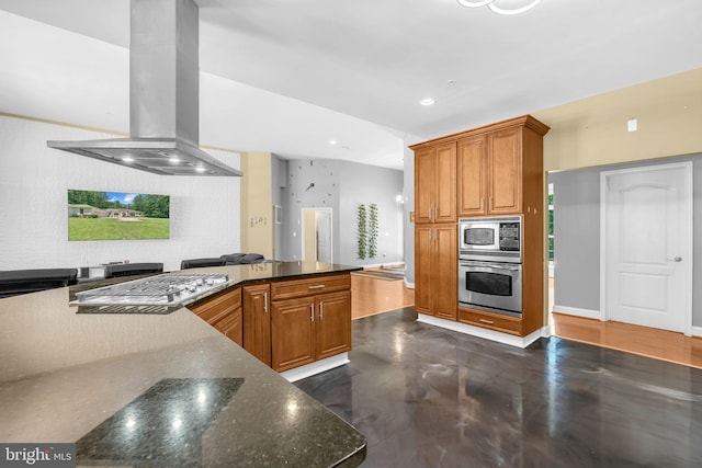 13716 Molly Berry Rd, Brandywine, MD 20613 - kitchen with appliances with stainless steel finishes, island exhaust hood, brown cabinetry, dark stone counters, and recessed lighting