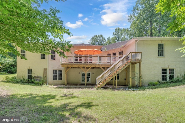 13716 Molly Berry Rd, Brandywine, MD 20613 - rear view of house with a deck, brick siding, and a yard