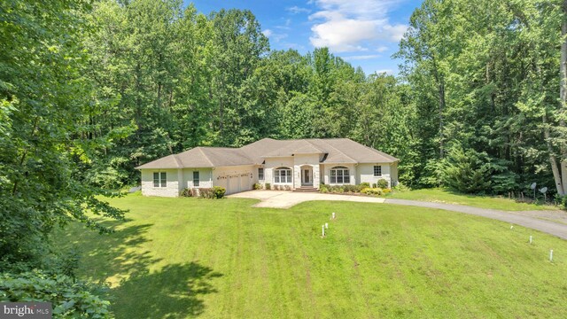 13716 Molly Berry Rd, Brandywine, MD 20613 - view of front of house featuring a garage, driveway, a front lawn, and a wooded view