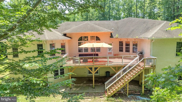 13716 Molly Berry Rd, Brandywine, MD 20613 - back of property with a shingled roof, a wooden deck, brick siding, and stairs