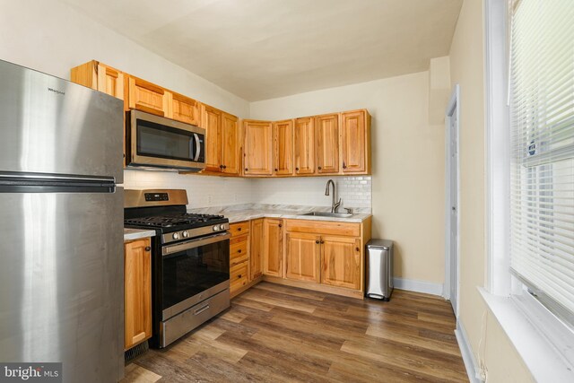 2929 N W St, Wilmington, DE 19802 - kitchen with stainless steel appliances, light countertops, backsplash, and dark wood-type flooring