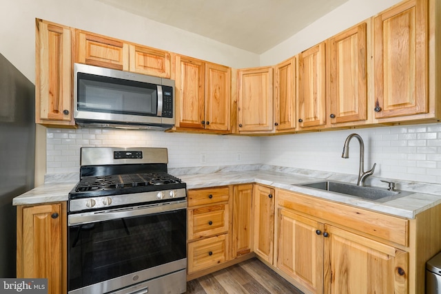 2929 N W St, Wilmington, DE 19802 - kitchen with stainless steel appliances, wood finished floors, and tasteful backsplash