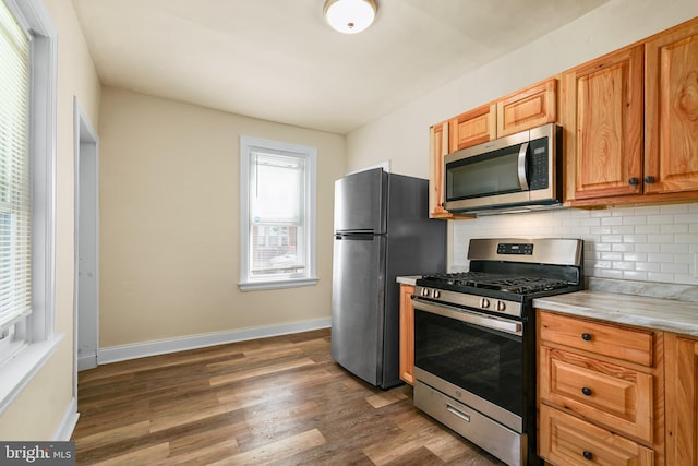 2929 N W St, Wilmington, DE 19802 - kitchen with stainless steel appliances, backsplash, dark wood-style flooring, and light countertops