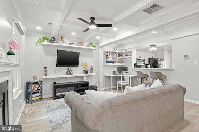 14983 Cheyenne Way, Haymarket, VA 20169 - living area with a glass covered fireplace, a ceiling fan, coffered ceiling, crown molding, and beamed ceiling