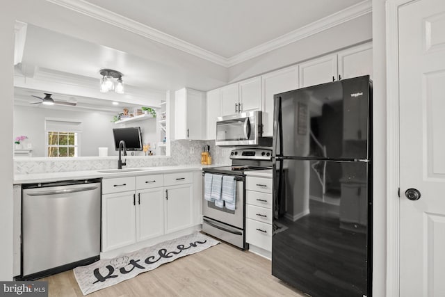 14983 Cheyenne Way, Haymarket, VA 20169 - kitchen with stainless steel appliances, ornamental molding, light countertops, white cabinetry, and light wood-style floors