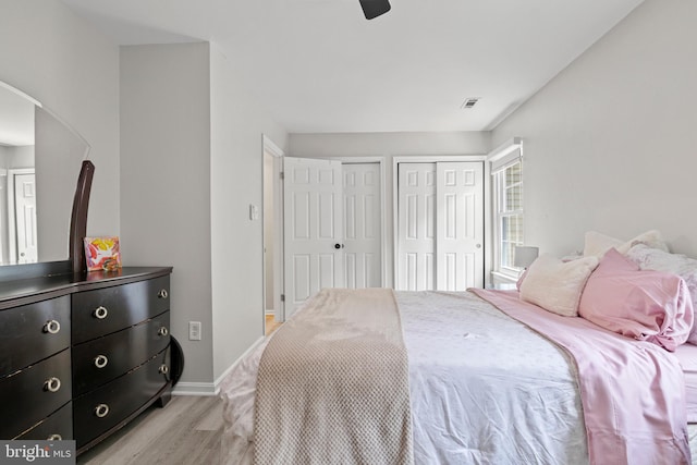 14983 Cheyenne Way, Haymarket, VA 20169 - bedroom featuring multiple closets, light wood-style flooring, arched walkways, and ceiling fan