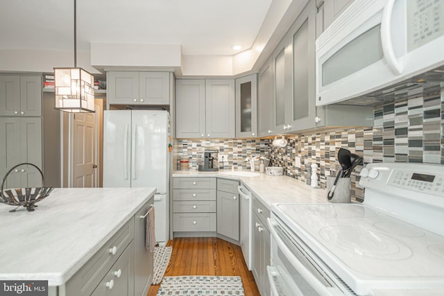 151 N Union St Unit 6, Lambertville, NJ 08530 - kitchen with white appliances, gray cabinets, light wood-type flooring, pendant lighting, and glass insert cabinets