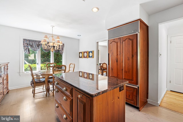6 Steeplechase Ln, Blue Bell, PA 19422 - kitchen featuring paneled built in fridge, light wood-style floors, dark stone countertops, a chandelier, and recessed lighting