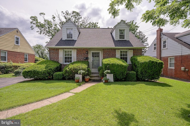 127 Long Rd, King Of Prussia, PA 19406 - cape cod-style house with brick siding, a front yard, and a shingled roof