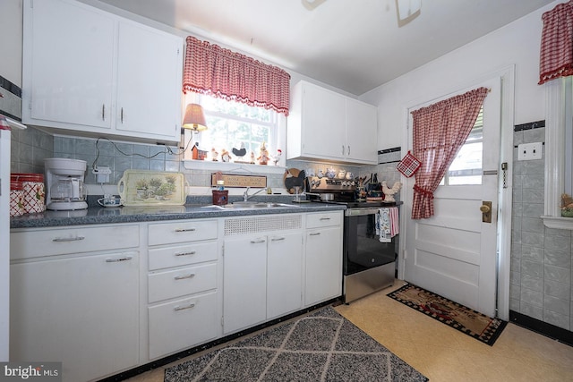 127 Long Rd, King Of Prussia, PA 19406 - kitchen featuring electric range, dark countertops, healthy amount of natural light, and white cabinets