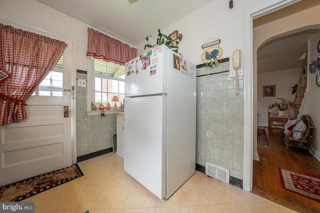 127 Long Rd, King Of Prussia, PA 19406 - kitchen featuring freestanding refrigerator, tile walls, and light tile patterned flooring