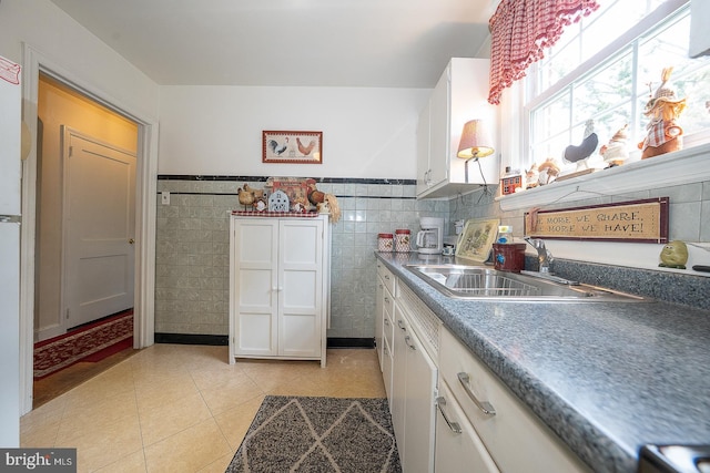 127 Long Rd, King Of Prussia, PA 19406 - kitchen featuring white cabinets, light tile patterned floors, tile walls, and wainscoting