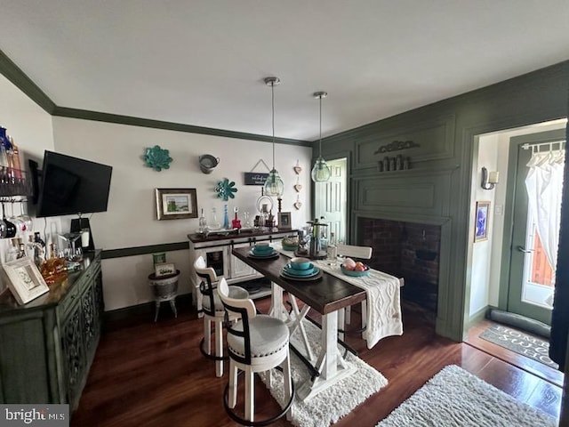 33 Aspen Ct, Bordentown, NJ 08505 - dining space featuring dark wood-style floors, ornamental molding, and a fireplace