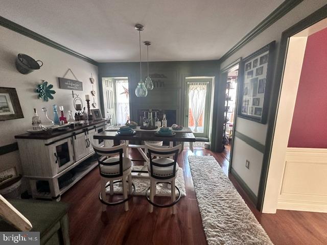 33 Aspen Ct, Bordentown, NJ 08505 - dining space featuring crown molding, dark wood-style flooring, and wainscoting