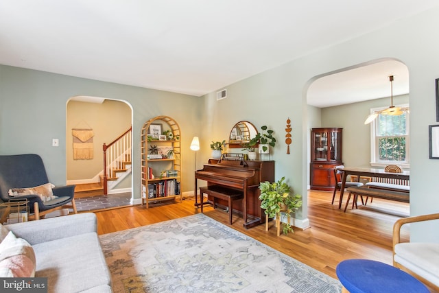 3909 17th St NE, Washington, DC 20018 - living area with arched walkways, stairway, and wood finished floors