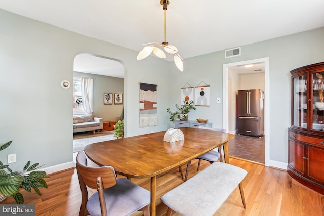3909 17th St NE, Washington, DC 20018 - dining area with arched walkways and light wood-style floors