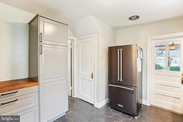 3909 17th St NE, Washington, DC 20018 - kitchen with high end fridge, wood counters, and dark tile patterned flooring
