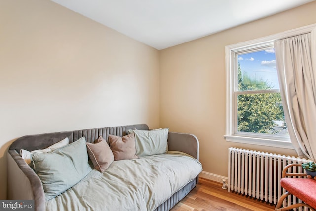 3909 17th St NE, Washington, DC 20018 - bedroom featuring radiator heating unit and wood finished floors