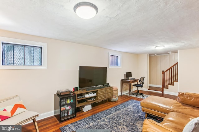3909 17th St NE, Washington, DC 20018 - living area featuring stairway, wood finished floors, healthy amount of natural light, and a textured ceiling