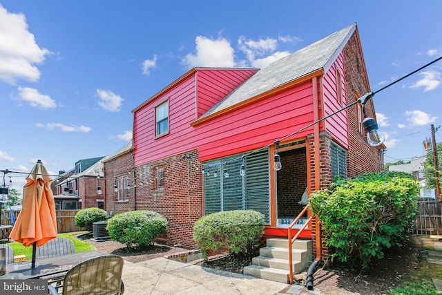 3909 17th St NE, Washington, DC 20018 - view of front of home with brick siding, a shingled roof, and a patio area