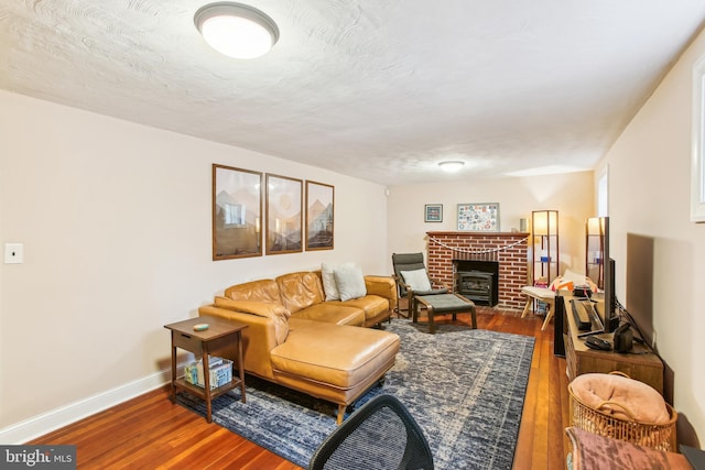 3909 17th St NE, Washington, DC 20018 - living room featuring hardwood / wood-style flooring and a brick fireplace