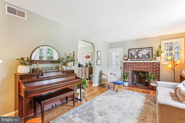 3909 17th St NE, Washington, DC 20018 - living area with arched walkways, wood finished floors, and a brick fireplace