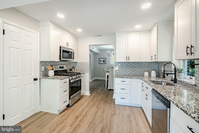 147 Meadowbrook Ave, Upper Darby, PA 19082 - kitchen featuring appliances with stainless steel finishes, light wood-style flooring, white cabinetry, and recessed lighting