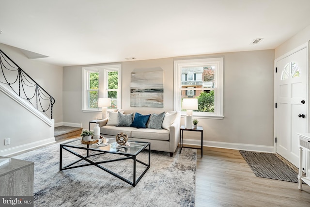 147 Meadowbrook Ave, Upper Darby, PA 19082 - living area with wood finished floors, stairway, and healthy amount of natural light