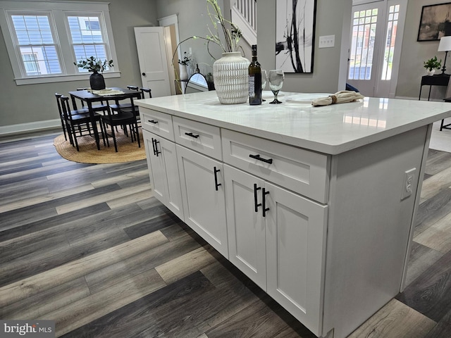 2900 Westfield Ave, Baltimore, MD 21214 - kitchen with dark wood finished floors, white cabinetry, a center island, and light stone counters