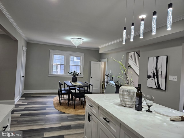 2900 Westfield Ave, Baltimore, MD 21214 - kitchen with crown molding, dark wood finished floors, pendant lighting, white cabinets, and light stone counters