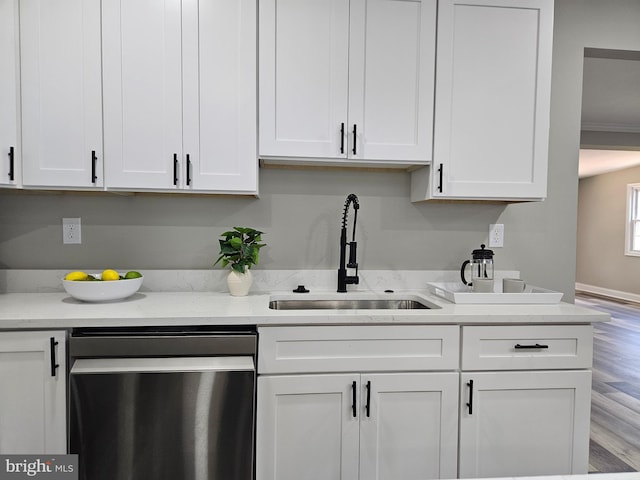 2900 Westfield Ave, Baltimore, MD 21214 - kitchen with dishwashing machine, white cabinetry, light wood-style flooring, and light stone counters