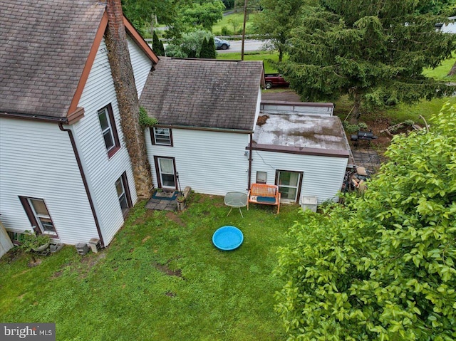 3854-3856 Schuylkill Rd, Spring City, PA 19475 - rear view of house featuring roof with shingles, a chimney, and a lawn