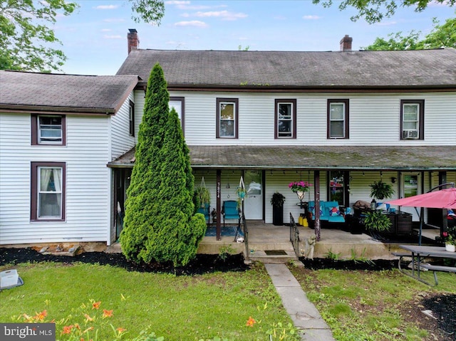 3854-3856 Schuylkill Rd, Spring City, PA 19475 - townhome / multi-family property with a chimney, a front yard, and covered porch