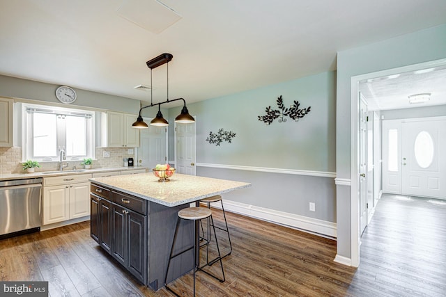 121 Pine Valley Dr, Middletown, DE 19709 - kitchen featuring dishwasher, a breakfast bar area, dark wood finished floors, and tasteful backsplash