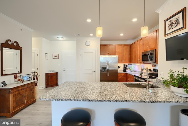 401 Bold Ruler Ct Unit 403, Havre De Grace, MD 21078 - kitchen featuring stainless steel appliances, a peninsula, light stone counters, ornamental molding, and a kitchen breakfast bar