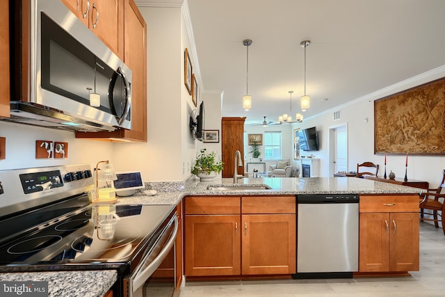 401 Bold Ruler Ct Unit 403, Havre De Grace, MD 21078 - kitchen with appliances with stainless steel finishes, brown cabinetry, a peninsula, light stone countertops, and crown molding