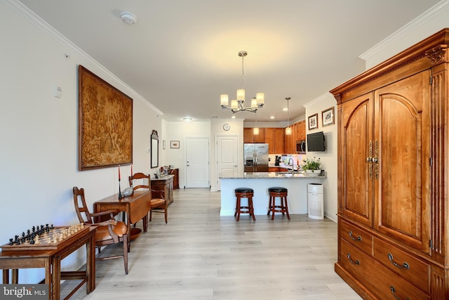 401 Bold Ruler Ct Unit 403, Havre De Grace, MD 21078 - kitchen featuring stainless steel appliances, a chandelier, light wood finished floors, a peninsula, and a kitchen breakfast bar