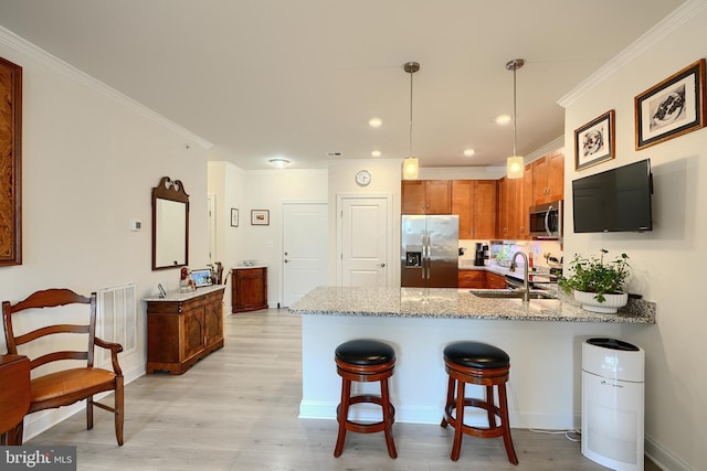401 Bold Ruler Ct Unit 403, Havre De Grace, MD 21078 - kitchen featuring stainless steel appliances, a peninsula, a breakfast bar, light wood finished floors, and light stone counters