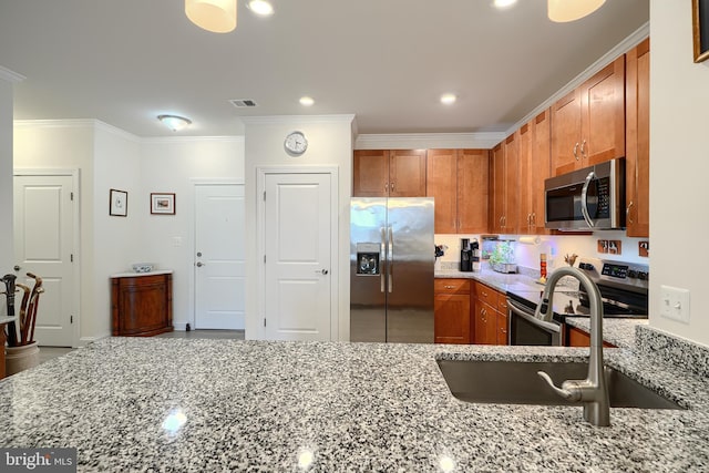 401 Bold Ruler Ct Unit 403, Havre De Grace, MD 21078 - kitchen featuring appliances with stainless steel finishes, light stone countertops, brown cabinets, ornamental molding, and recessed lighting