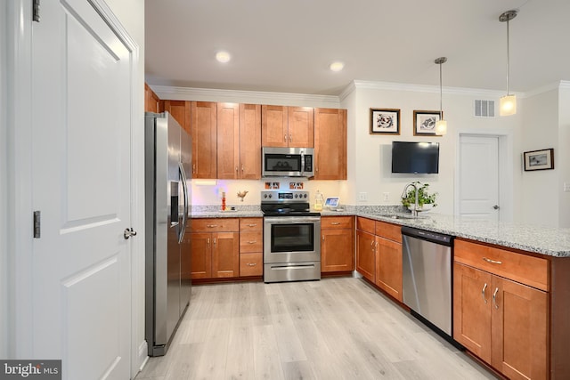 401 Bold Ruler Ct Unit 403, Havre De Grace, MD 21078 - kitchen with appliances with stainless steel finishes, crown molding, a peninsula, brown cabinetry, and light wood-style flooring