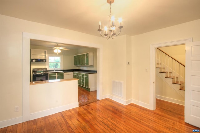 618 S 1st St, Charlottesville, VA 22902 - kitchen with black electric range, ventilation hood, hardwood / wood-style flooring, green cabinets, and a chandelier