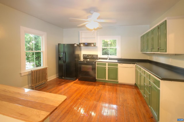 618 S 1st St, Charlottesville, VA 22902 - kitchen featuring green cabinetry, black appliances, radiator, dark countertops, and healthy amount of natural light
