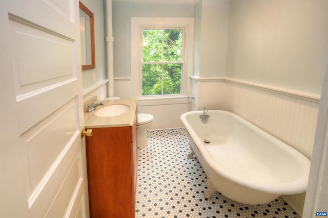 618 S 1st St, Charlottesville, VA 22902 - bathroom with vanity, a wainscoted wall, a freestanding tub, and a decorative wall