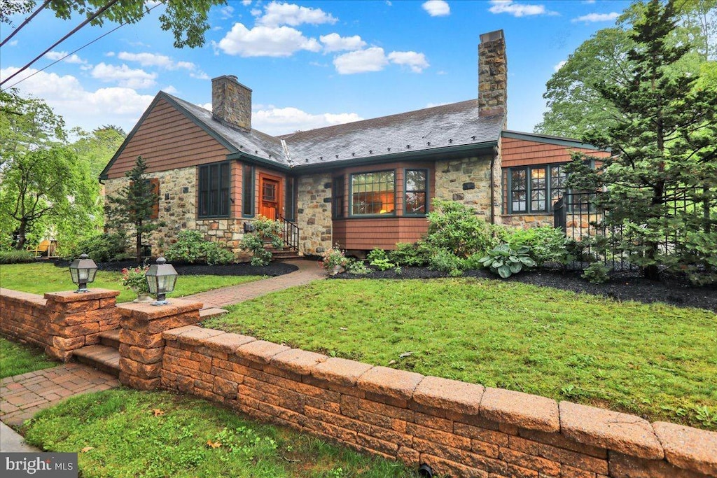 615 Wyoming Ave, Reading, PA 19610 - view of front of home featuring stone siding, a chimney, a high end roof, and a front yard