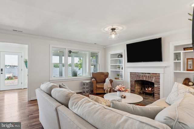 1045 Back Bay Beach Rd, West River, MD 20778 - living room with ornamental molding, a brick fireplace, wood finished floors, and built in features