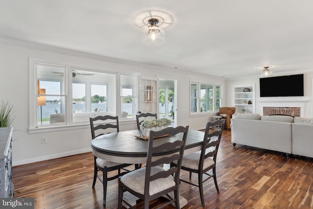 1045 Back Bay Beach Rd, West River, MD 20778 - dining space with dark wood-style flooring, healthy amount of natural light, ornamental molding, and built in shelves