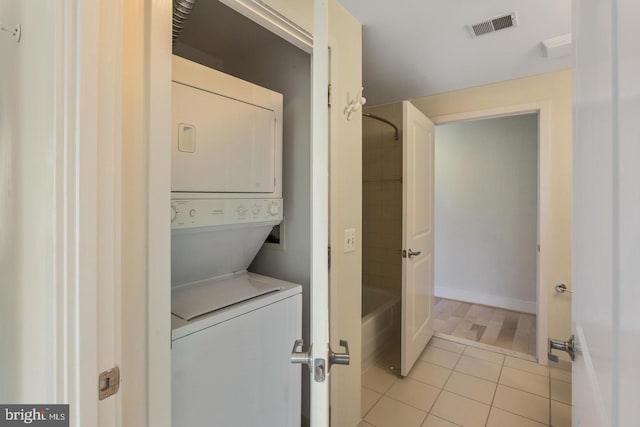2001 15th St N Unit 319, Arlington, VA 22201 - laundry room with stacked washer and clothes dryer and light tile patterned flooring